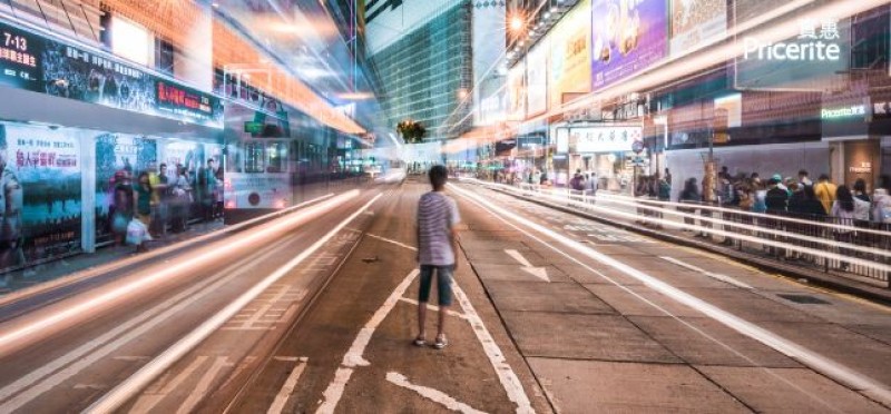 A man in the middle of a busy street